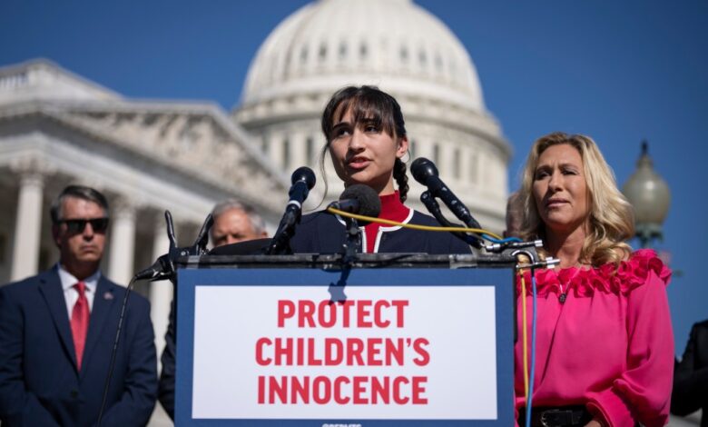 Chloe Cole speaks as Rep. Marjorie Taylor Greene (R-GA) looks on during a news conference on Capitol Hill September 20, 2022 in Washington, DC.