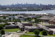 Rikers Island jail complex in New York with the Manhattan skyline in the background