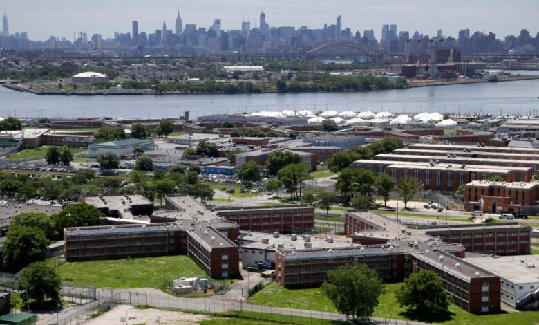 Rikers Island jail complex in New York with the Manhattan skyline in the background