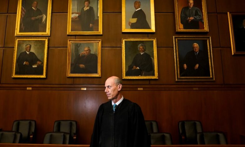 Judge Boasberg in front of wall with judges' portraits