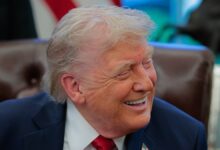 U.S. President Donald Trump smiles as he speaks to the media