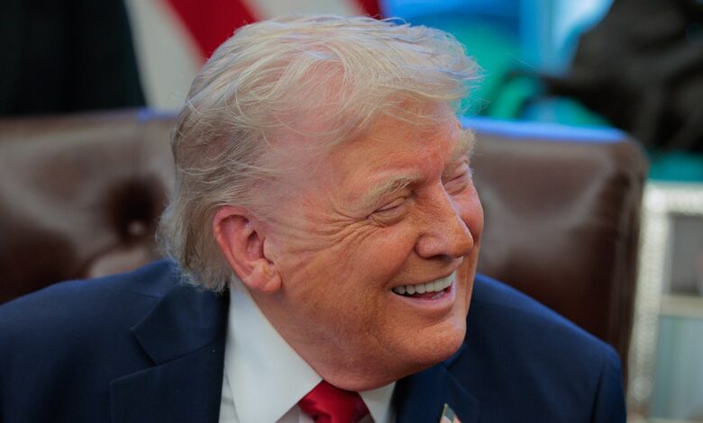 U.S. President Donald Trump smiles as he speaks to the media