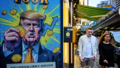 Cryptocurrency exchange office in Hong Kong with a screen featuring President Trump holding cryptocurrency coins.