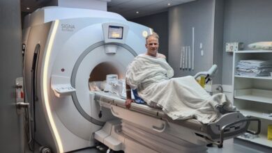Scolyer poses on and MRI machine