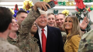 President Donald Trump and first lady Melania Trump greet military personnel in the dining facility during an unannounced visit to Al Asad Air Base in Iraq on Dec. 26, 2018.