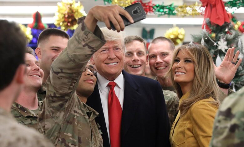 President Donald Trump and first lady Melania Trump greet military personnel in the dining facility during an unannounced visit to Al Asad Air Base in Iraq on Dec. 26, 2018.