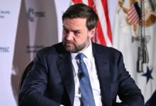JD Vance looks serious on stage of DC Munich Security Conference event