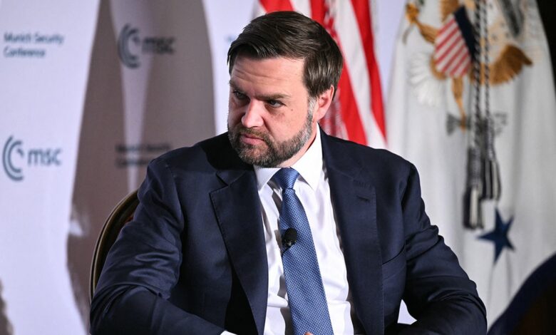 JD Vance looks serious on stage of DC Munich Security Conference event