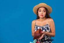 young woman holding empty wallet