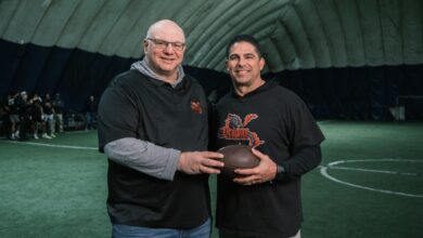 Peter Schwartz and Gerald Filardi holding a football.