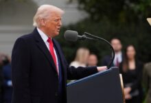 Donald Trump speaking at a podium.
