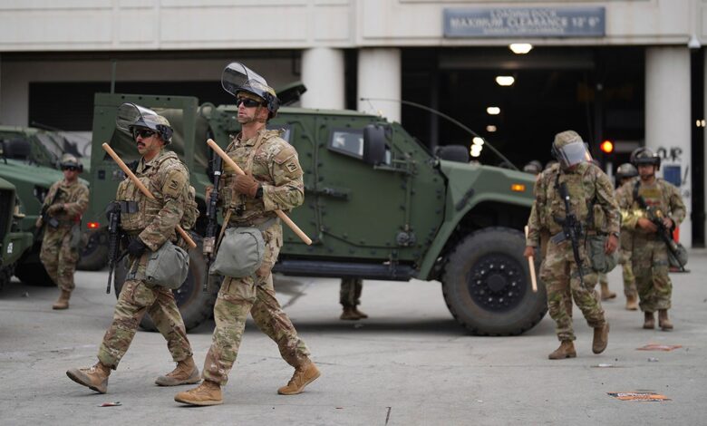 U.S. National Guard troops with nightsticks