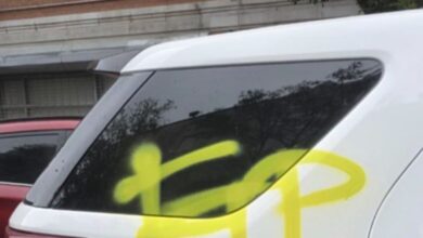 Graffiti on a damaged NYPD vehicle.