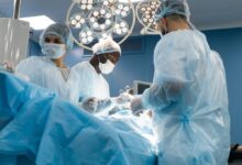 Surgeons performing an operation in a modern hospital operating room.