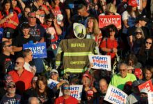 Corey Comperatore’s turnout coat is displayed in the crowd during a moment of silence at a Trump rally in Butler, Pa., honoring the slain volunteer fire chief.