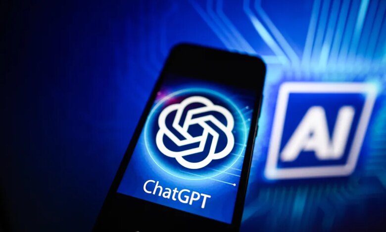 Photo illustration of a ChatGPT logo displayed on a smartphone with an AI logo in the background.