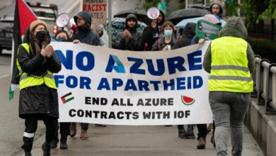 Demonstrators holding a banner that reads "NO AZURE FOR APARTHEID END ALL AZURE CONTRACTS WITH IOF" during a rally in Seattle.