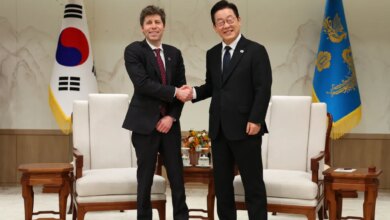 South Korean President Lee Jae-myung shakes hands with OpenAI CEO Sam Altman.