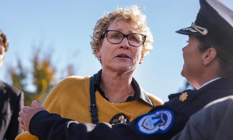 Rep. Chrissy Houlahan being held back by a police officer