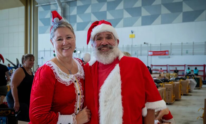 Beth and Jeff Roman, Operation Christmas Drop 2025 volunteers, pose for a photo during the bundle build and decoration for OCD25 at Andersen Air Force Base, Guam, Dec. 5, 2025.