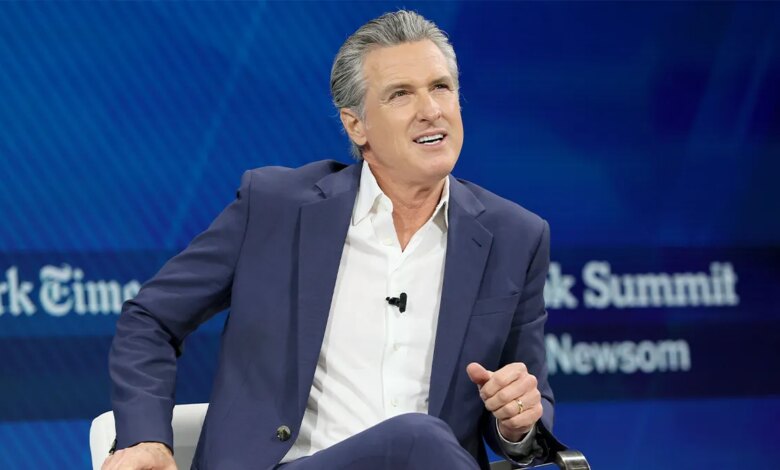 Gavin Newsom addresses an audience from an event stage.