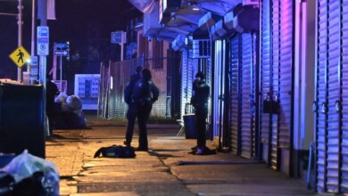 Police investigators working the scene of a mass shooting at Platinum Sound Studio in Newark, New Jersey.