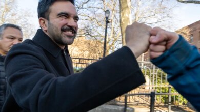 Zohran Mamdani fist-bumping a supporter.