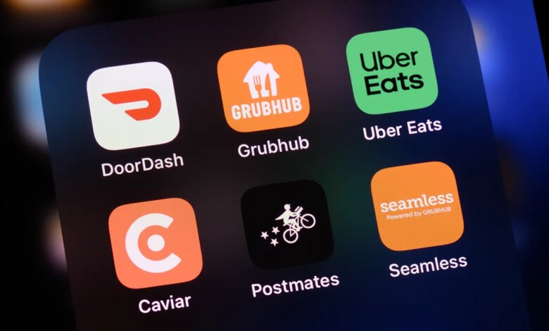 Food delivery apps seen on a screen, including DoorDash, GrubHub, Uber Eats, Caviar, Postmates and Seamless.