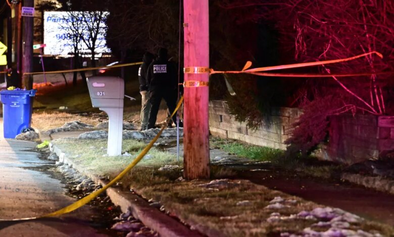 Piscataway police detectives at a crime scene with caution tape.