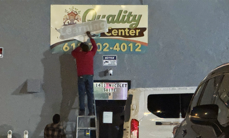 Quality Learning Center sign being fixed