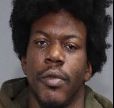 Mugshot of Germaine Parham, a 33-year-old male with dark skin and dark curly hair.