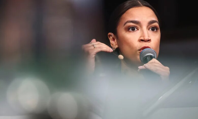 U.S. Representative Alexandria Ocasio-Cortez speaking into a microphone at the Munich Security Conference.