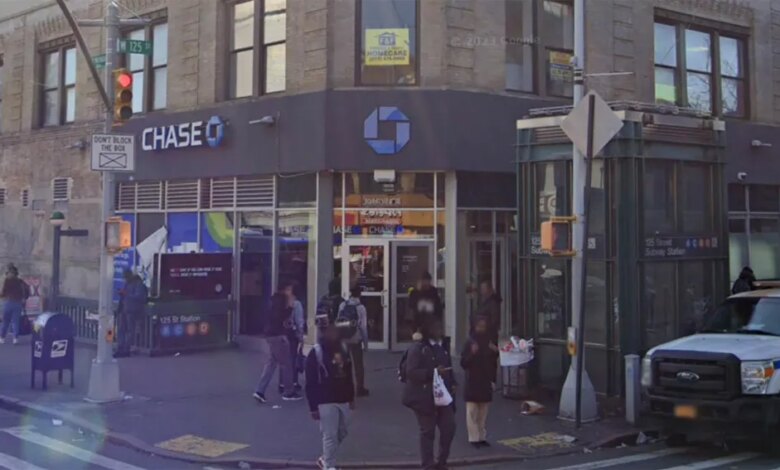 Street view of West 125 Street and St. Nicholas Avenue in New York City, featuring a Chase bank branch and a subway station entrance.