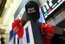 MAGA hats are hung on a wall as traders work on the floor of the New York Stock Exchange during morning trading on February 20th.
