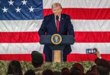 Donald Trump speaking at a podium with the Seal of the President of the United States, in front of an American flag.