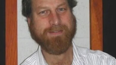 Headshot of Carl Grillmair, a white man with a balding head, brown hair, and a full brown beard, smiling.
