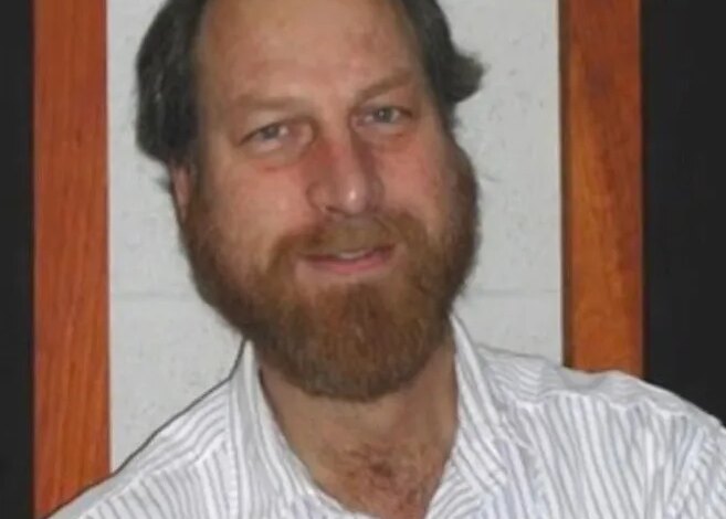 Headshot of Carl Grillmair, a white man with a balding head, brown hair, and a full brown beard, smiling.