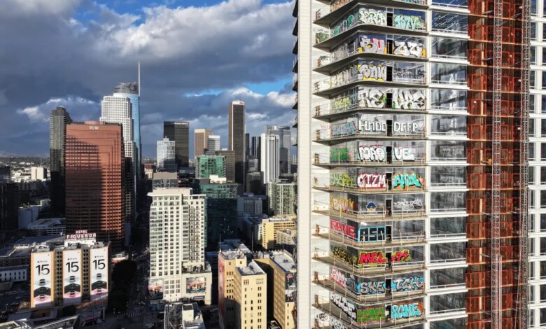 Aerial view of an unfinished skyscraper in Los Angeles covered in graffiti.
