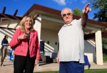 Kathryn Barger and Ted Koerner standing outside Koerner's newly rebuilt home.