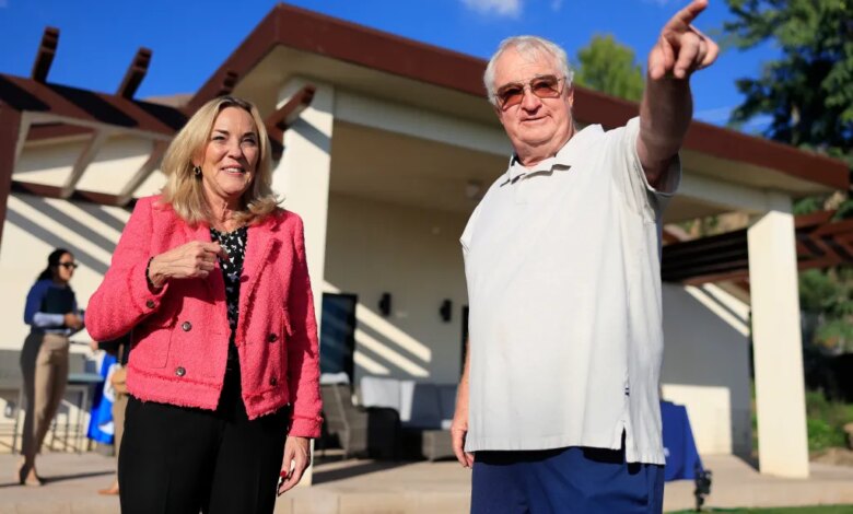 Kathryn Barger and Ted Koerner standing outside Koerner's newly rebuilt home.