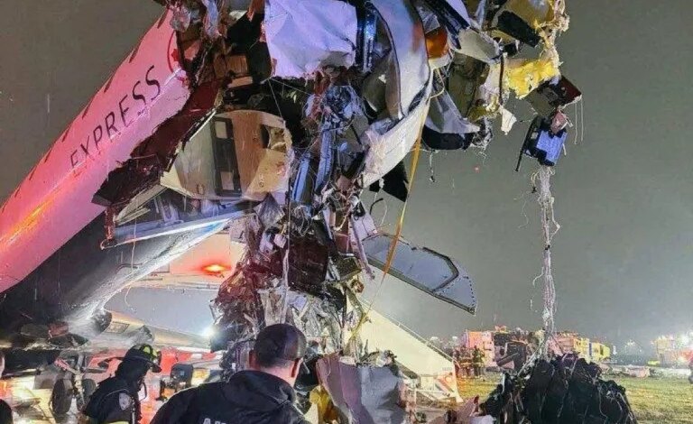 Debris hangs from the front of a damaged Air Canada Express jet after colliding with a Port Authority fire truck at LaGuardia Airport.