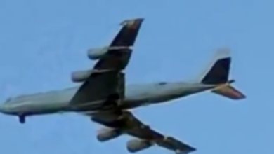 A Boeing E-6B Mercury "Doomsday Plane" flying through a blue sky.