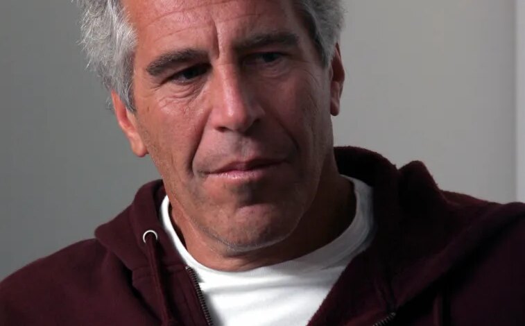 Jeffrey Epstein in a maroon Harvard University hoodie.