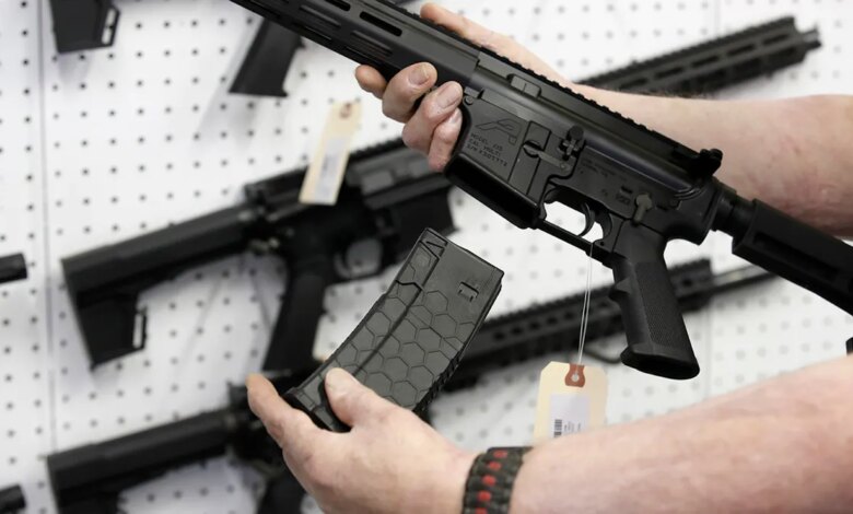 Person holds AR-15 rifle magazine