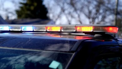 A police car's emergency light bar with flashing red and blue lights.