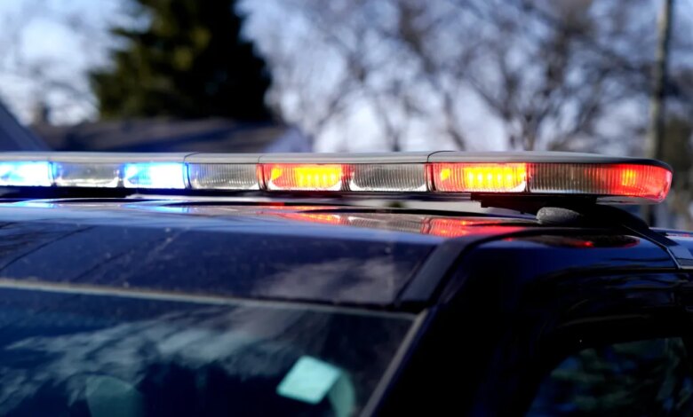 A police car's emergency light bar with flashing red and blue lights.
