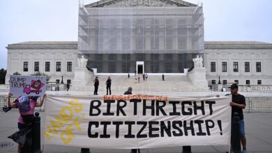 Protesters hold up birthright citizenship banner outside Supreme Court