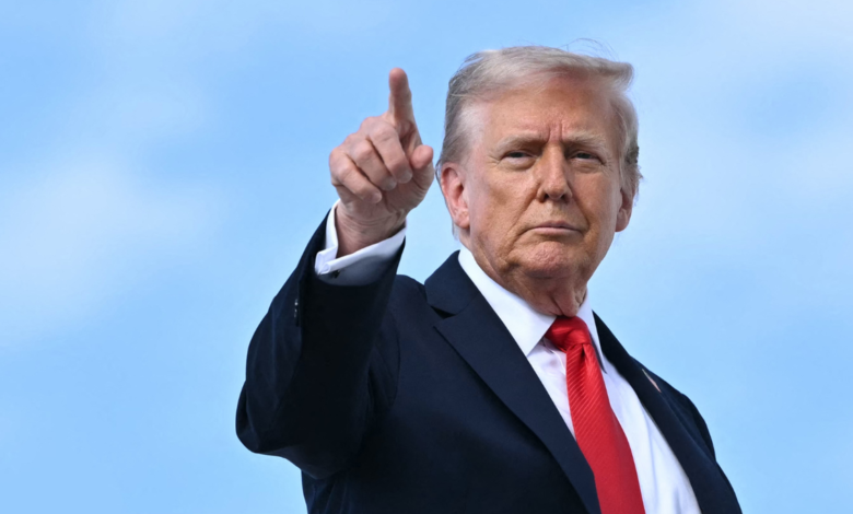 U.S. President Donald Trump points at cameras before boarding Air Force One