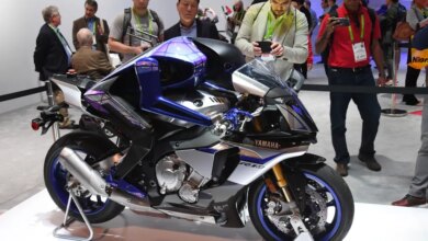Attendees looking at the Yamaha Motobot autonomous motorcycle-riding humanoid robot.