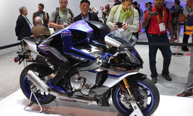 Attendees looking at the Yamaha Motobot autonomous motorcycle-riding humanoid robot.